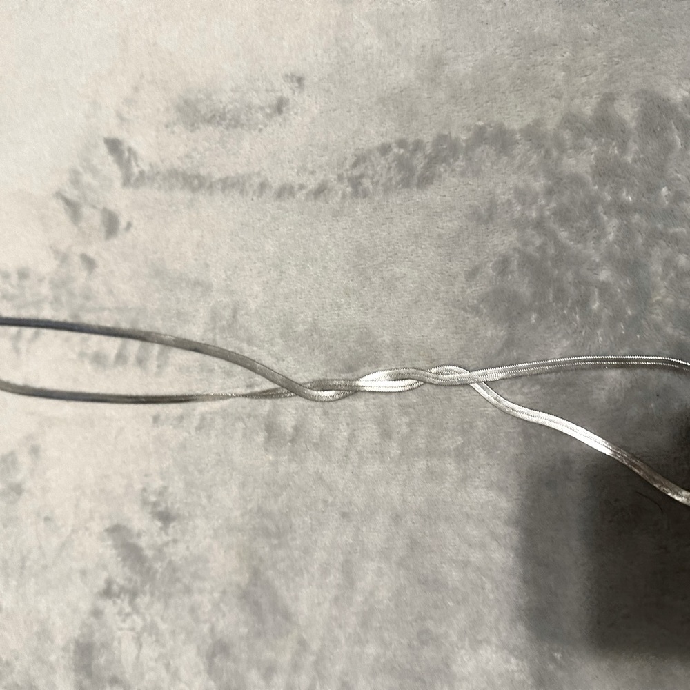 Silver herringbone necklace.